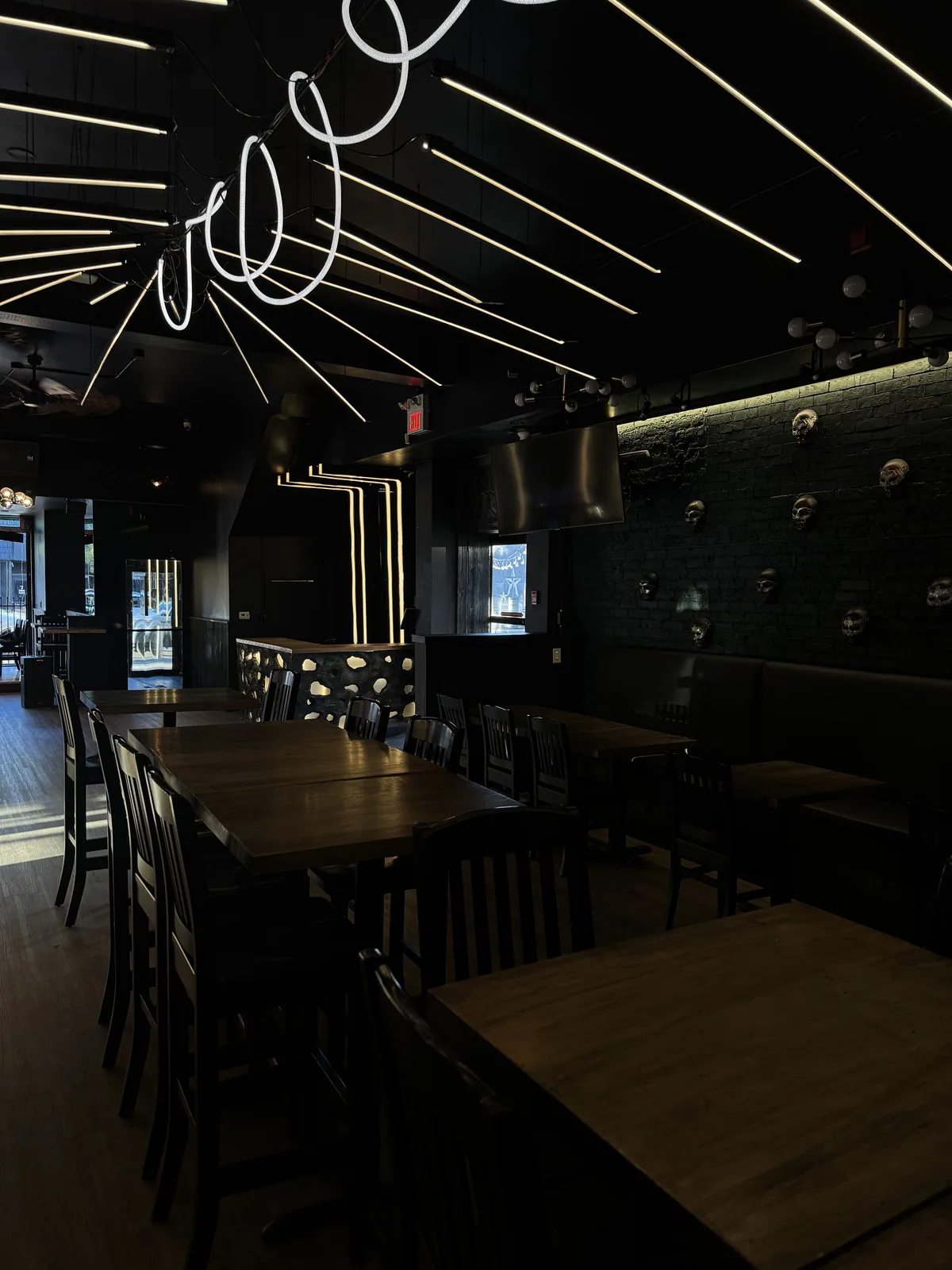 Dining tables beneath illuminated ceiling details at Début